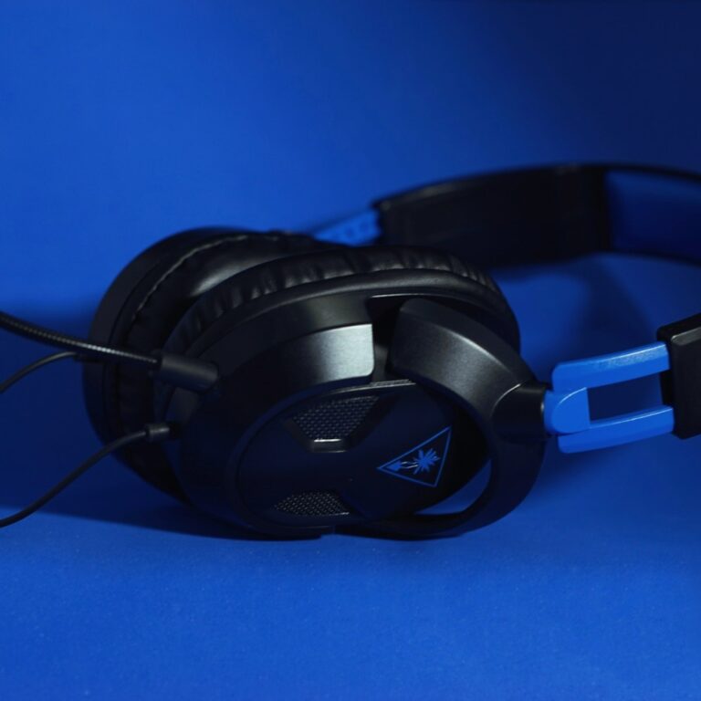 A headset beside a computer screen