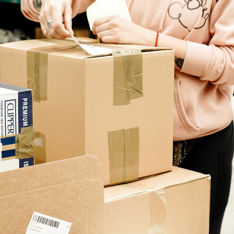 Someone labelling a package for shipping