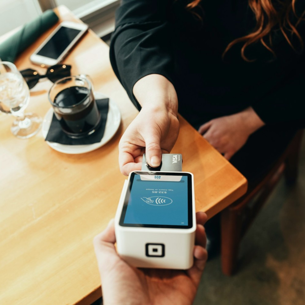 A person holding a card payment machine