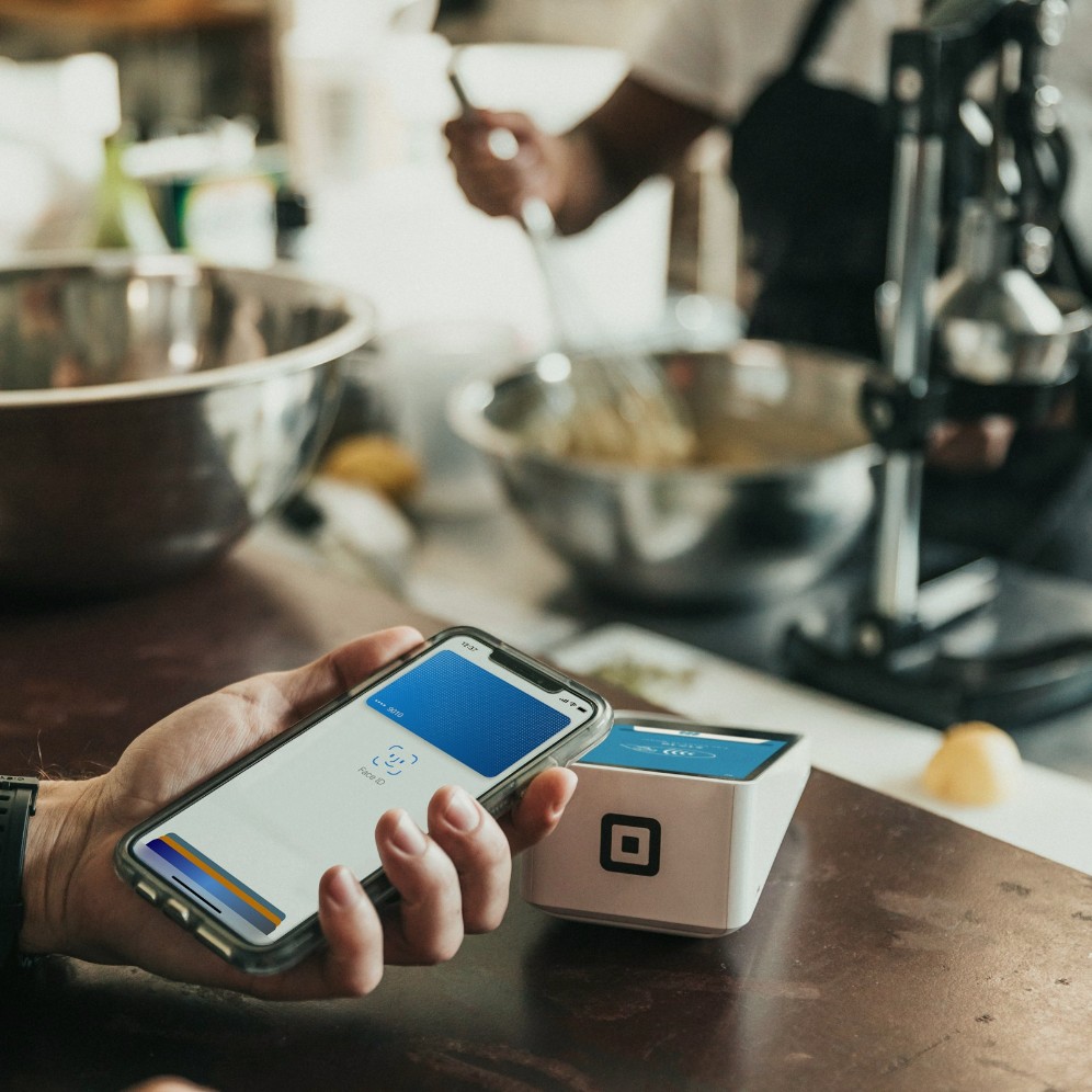 A phone held near a contactless payment terminal